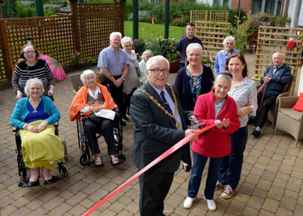 The Mayor of Hartlepool, Coun Paul Beck, with his Mayoress and wife Mary, open the new patio garden at Hartfields with a helping hand from designer Christina Rees, right, and resident Jean Dawson, with fellow residents looking on.