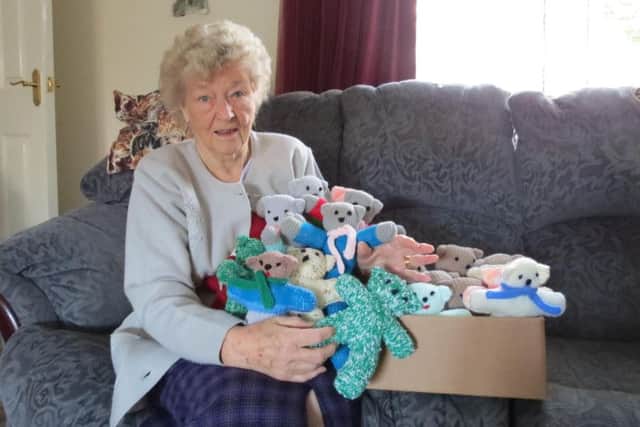 Pauline Robinson with the knitted teddies.