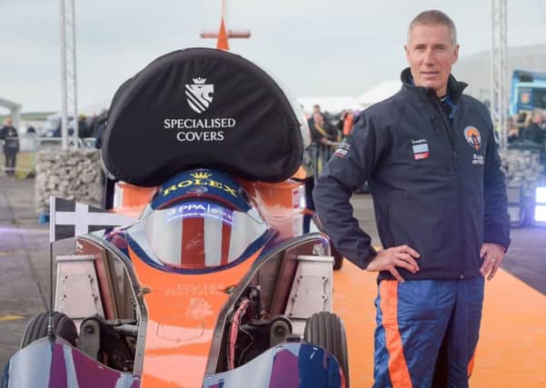 Pilot Andy Green stands beside the Bloodhound 1,000mph supersonic racing car before its first public run at Cornwall Airport, near Newquay. PRESS ASSOCIATION Photo. Picture date: Thursday October 26, 2017. See PA story TRANSPORT Bloodhound. Photo credit should read: Ben Birchall/PA Wire