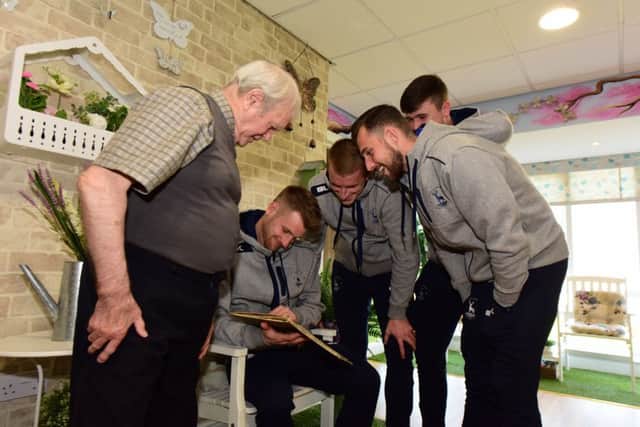 Hartlepool United players visiting Sheraton Court, Warren Road, Hartlepool, where they met resident and former Pools player Joe Ryamant. Looking at Joe's scrapbook from his playing days are Pools players Lewis Hawkins, Scott Harrison, Ryan Catterick and Jonathan Franks.