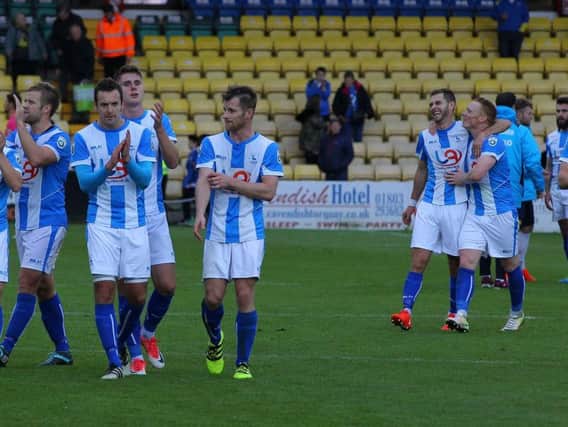 Hartlepool United's players applaud the away fans at Torquay