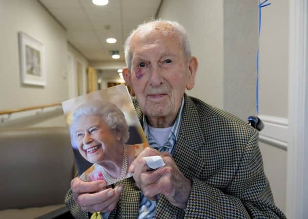 Sheraton Court resident Tom Larke holds his 100th birthday card from Her Majesty Queen Elizabeth II. Picture by FRANK REID