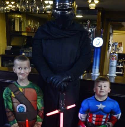 McKenzie, left, and Lucas Liddle pictured with one of their Star Wars heroes.