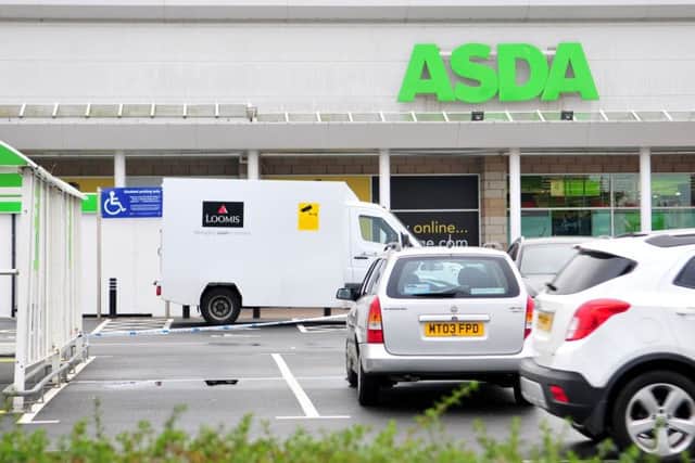 A security van in a taped off area in Asda car park Marina Way.