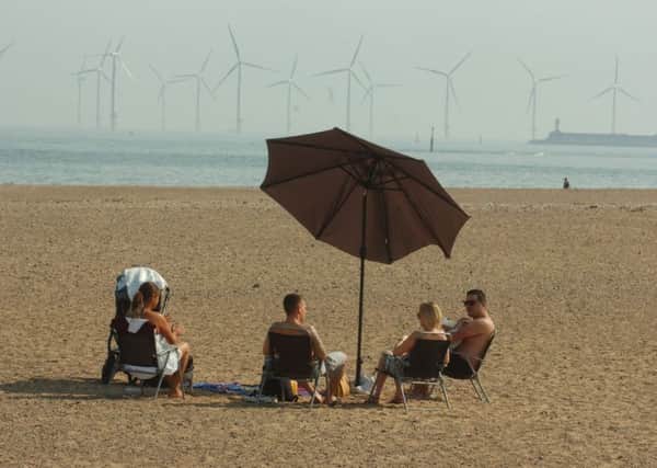 A family enjoy a picnic on the beach at Seaton Carew.