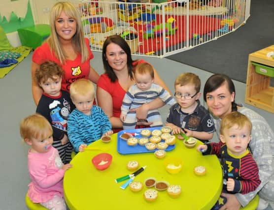 Cheeky Monkeys Nursery staff and children making cup cakes in aid of Children In Need in 2012.