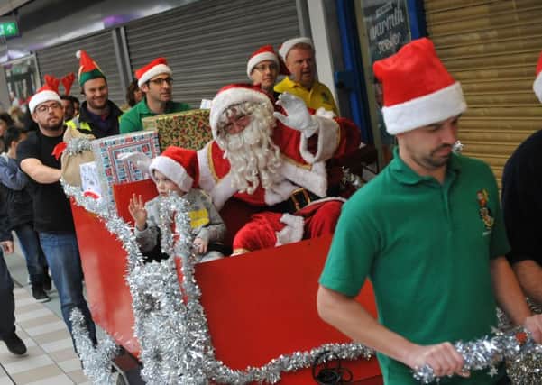 Santa arrives at Hartlepool's Middleton Grange Shopping Centre last year, accompanied by Alfie Smith, and Mayor Coun Rob Cook.