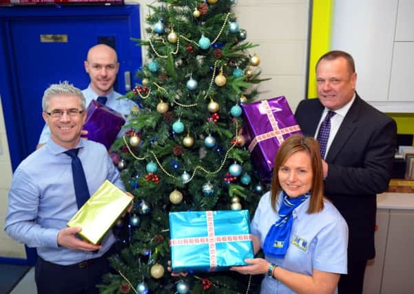 MKM Building Supplies staff (rear) Duncan Slater and Michael Sumpter with (front) Lee Dees and Jane Plant with Christmas gifts as they launch the Hartlepool Mail Christmas Gift Appeal. Picture by FRANK REID