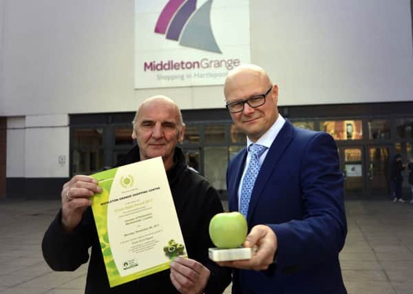 Middleton Grange Shopping Centre electrician Peter Rudd and centre manager Mark Rycraft with the Green Apple award.