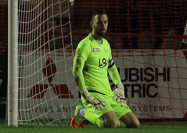 Pools keeper Scott Loach shows his disappointment after conceding the third goal.