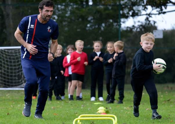 Former Hartlepool United midfield player Tommy Miller working with Seaton Carew Holy Trinity School pupil Ethan Andrews.  Picture by FRANK REID