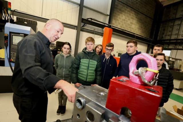 Managing Director at Omega Plastics, Gary Powner, with the engineering students from Dyke House Sports and Technology College in Hartlepool.