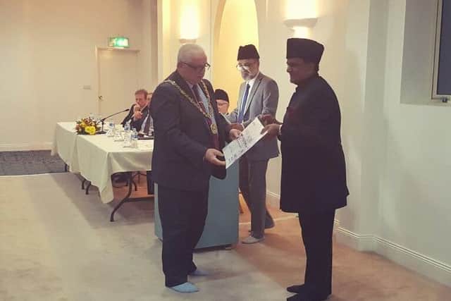 Rafiq Hayat presenting a cheque to the Mayor of Hartlepool, Coun Paul Beck.