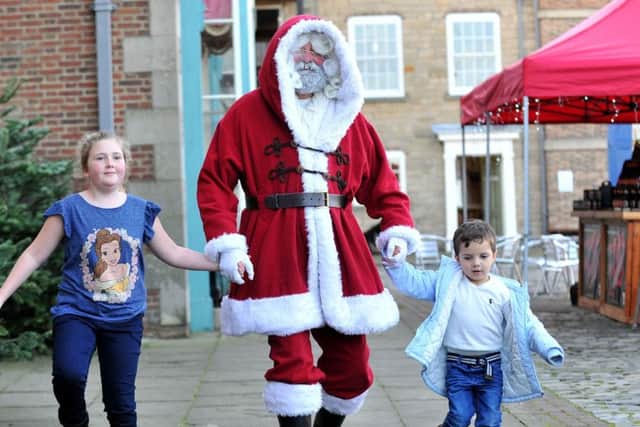 Charlotte McAleer (8) and Joel Newcombe (3) skipping with delight after their visit to Santa's Grotto at the Festival of Christmas. Picture by FRANK REID