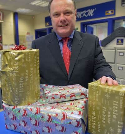 Mick Sumpter director at MKM with Christmas presents