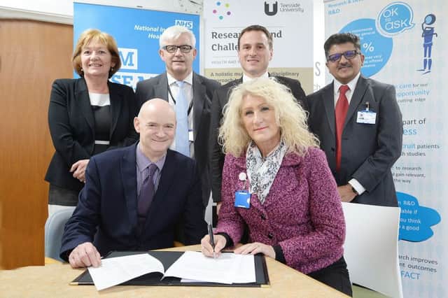 Chief executive Julie Gillon signs the Teesside University partnership.