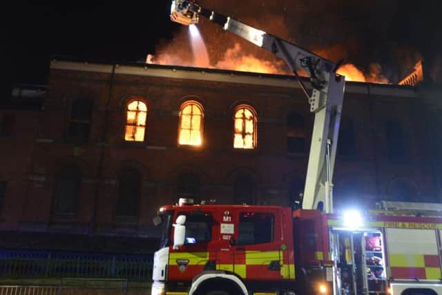 Firefighters tackle the blaze at the Wesley building. Picture by Tom Collins.