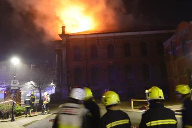 Firefighters tackle the blaze at the Wesley building. Picture by Tom Collins.