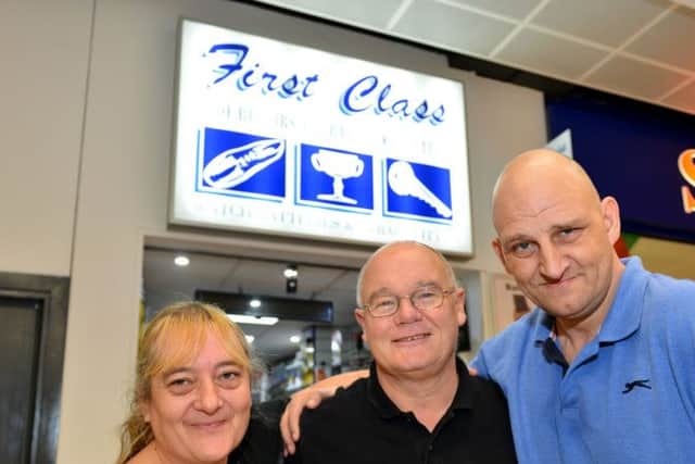 Bill Reid owner of First Class Shoe Repairs Key Cutting  and Engraving (right) with Jacky Wilkinson and Thomas Fletch after he presented them with their engraved wedding rings. Picture by FRANK REID