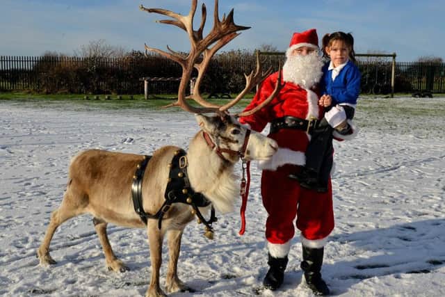 Santa Clause with Eskdale Academy pupil Fearne Staveley and Troy the Reindeer. Picture by FRANK REID