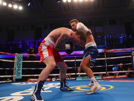 Greg O'Neil is hurt by a body shot from Felix Cash (right). Picture by LAWRENCE LUSTIG/ MATCHROOM RINGSIDE