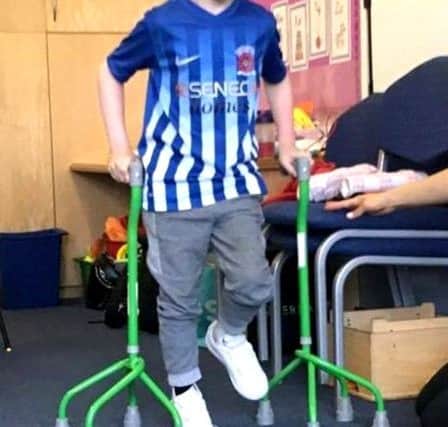 Alfie Smith is now able to walk short distances with his quad sticks.