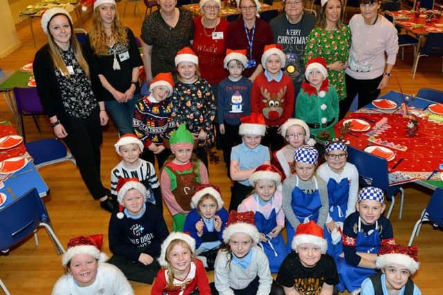 Pupils and staff pose for their photograph before the start of the Thornley Primary school OAP Christmas party.