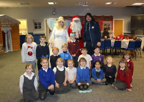 The children who enjoyed a great Christmas party thanks to Danielle and Craig Harrison pictured with Santa