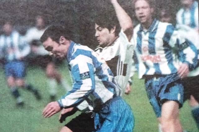 Denny Ingram clears under pressure from Paul Peschisolido.