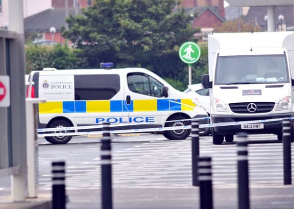 A police van next to a security van in a taped off area in Asda car park Marina Way.