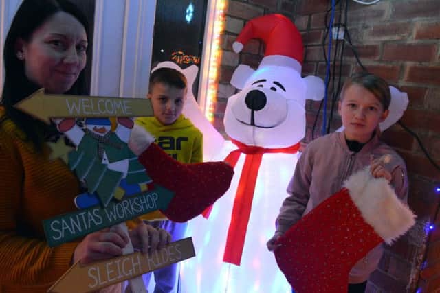 Michelle Simpson with children Shay Hogg, 11 and Maci-Jai Simpson, 11, outside their festive Hartlepool home.