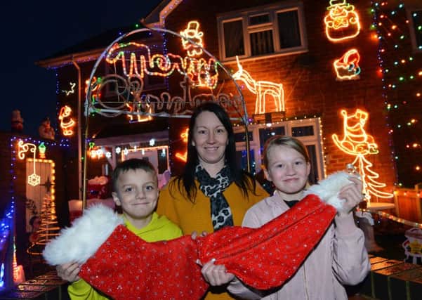 Hartlepool Stop, Look and Glisten Christmas house light decoration winners on Motherwell Road,
Michelle Simpson with children Shay Hogg, 11 and Macie-Jai Simpson, 11.