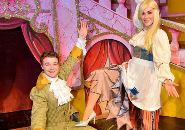 Prince Charming (Ben-Ryan Davies) puts the slips onto the foot of Cinderella (Lola Saunders) Cinderella, at the Billingham Forum Theatre. Picture by FRANK REID