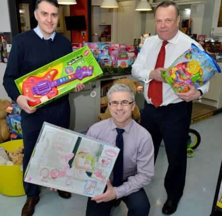 MKM staff (rear left to right) Neil Reed and Mick Sumpter with Lee Dees in front with donated Christmas gifts.