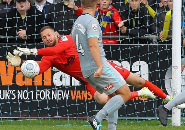 Hartlepool United goalkeeper Scott Loach makes yet another great save while playing against Solihull Moors.