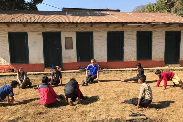 Jason Lund teaching dance moves to the children in Nepal.
