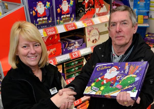 Janette Gillies team manager at the Headland branch of McColls with Kevin Jones from Hartlepool Carnival committee.
