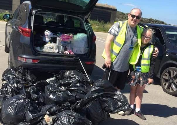 Jessica Stones and dad Kevin and the bags of rubbish collected in one of the the clean-ups.