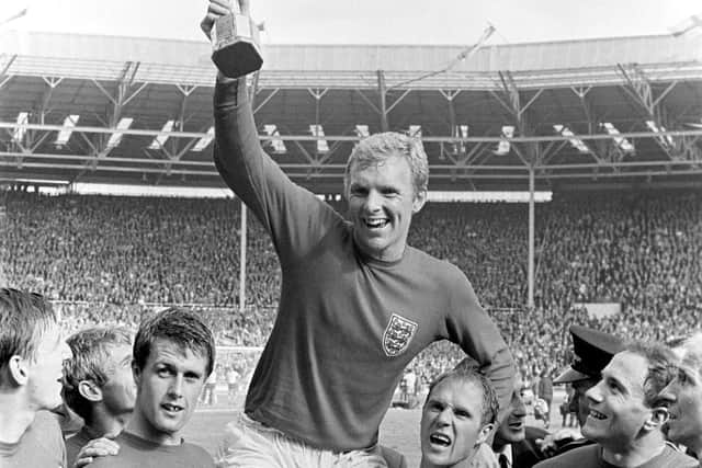 Geoff Hurst, left, with England captain Bobby Moore after the victorious World Cup final of 1966. Pic: PA.