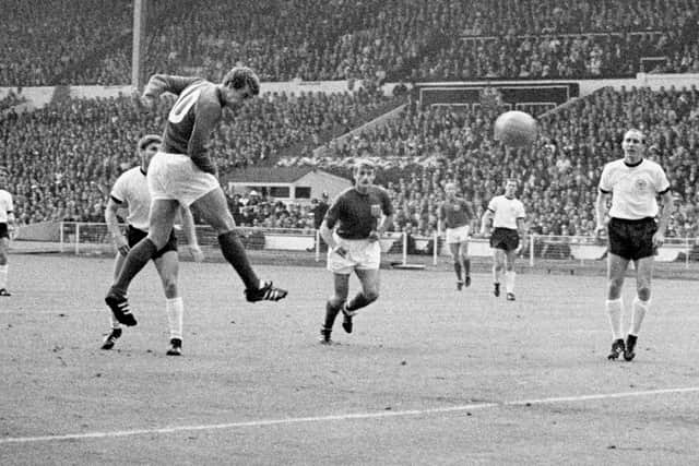 Geoff Hurst heads in one of his three goals in the 1966 World Cup final. Pic: PA.