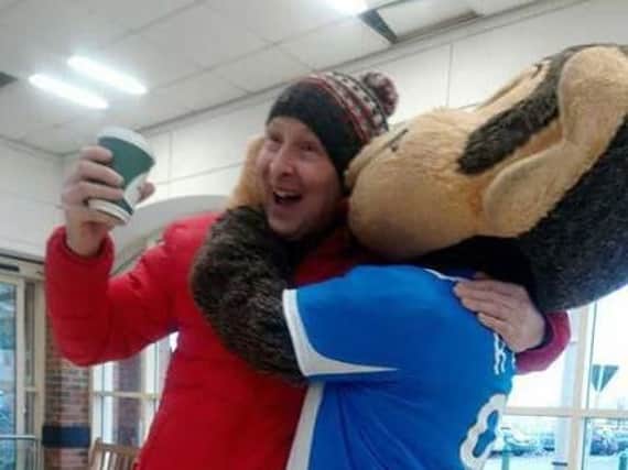 H'Angus - aka Michael Evans - shows his delight after one fan adds his donation to the collection bucket in Morrisons.