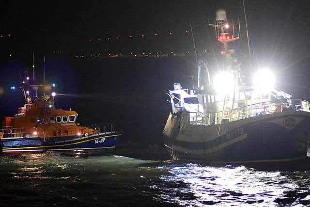 Hartlepool RNLI's all-weather lifeboat alongside the grounded fishing boat. Picture by Tom Collins.