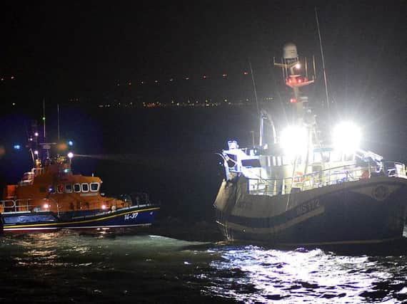Hartlepool RNLI's all-weather lifeboat alongside the grounded fishing boat. Picture by Tom Collins.