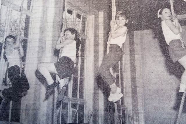 Eight-year-olds get to climb the ropes during a physical education session at Sacred Heart in 1972.