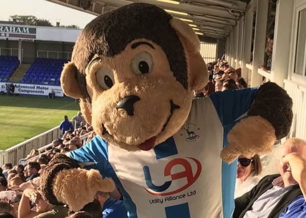 Hartlepool United mascot H'Angus wearing Pools' home shirt sponsored by Utility Alliance.