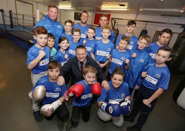Members of Horden Amateur Boxing Club with Club Secretary Liam Dineen (back row left) and Geoff Scott, Social and Economic Impact Manager for North East at Keepmoat Homes (centre).
