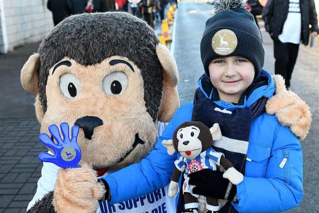 Hartlepool United trusty mascot H'Angus with young fan Harry Preston.