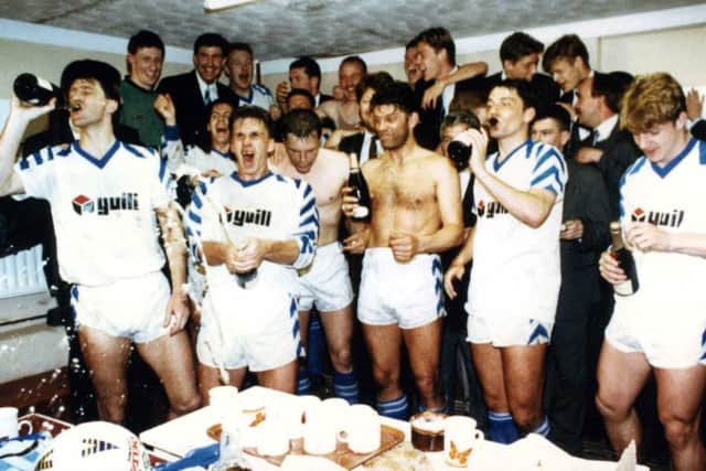 The players celebrate after a well-deserved promotion.