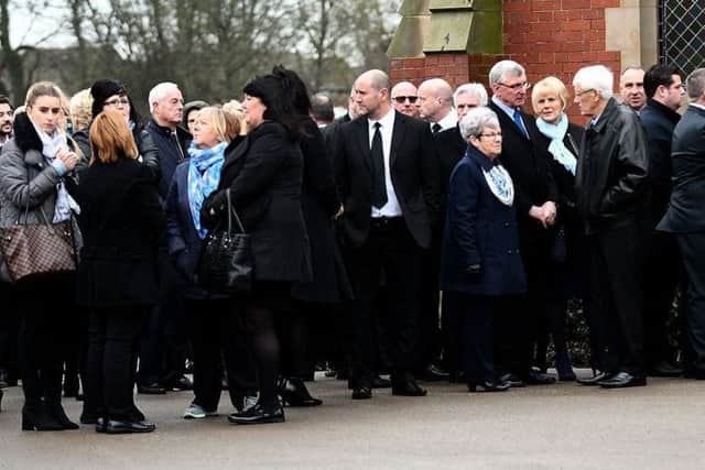 Mourners wear blue as they attend the funeral of Dean Moore at Stranton Crematorium.