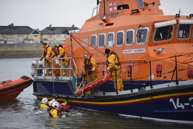 Hartlepool RNLI volunteer crew members Stephen Clyburn and Richard Shaw (right) dealing with one of the casualties on the all weather lifeboat. Picture: RNLI/Tom Colins.